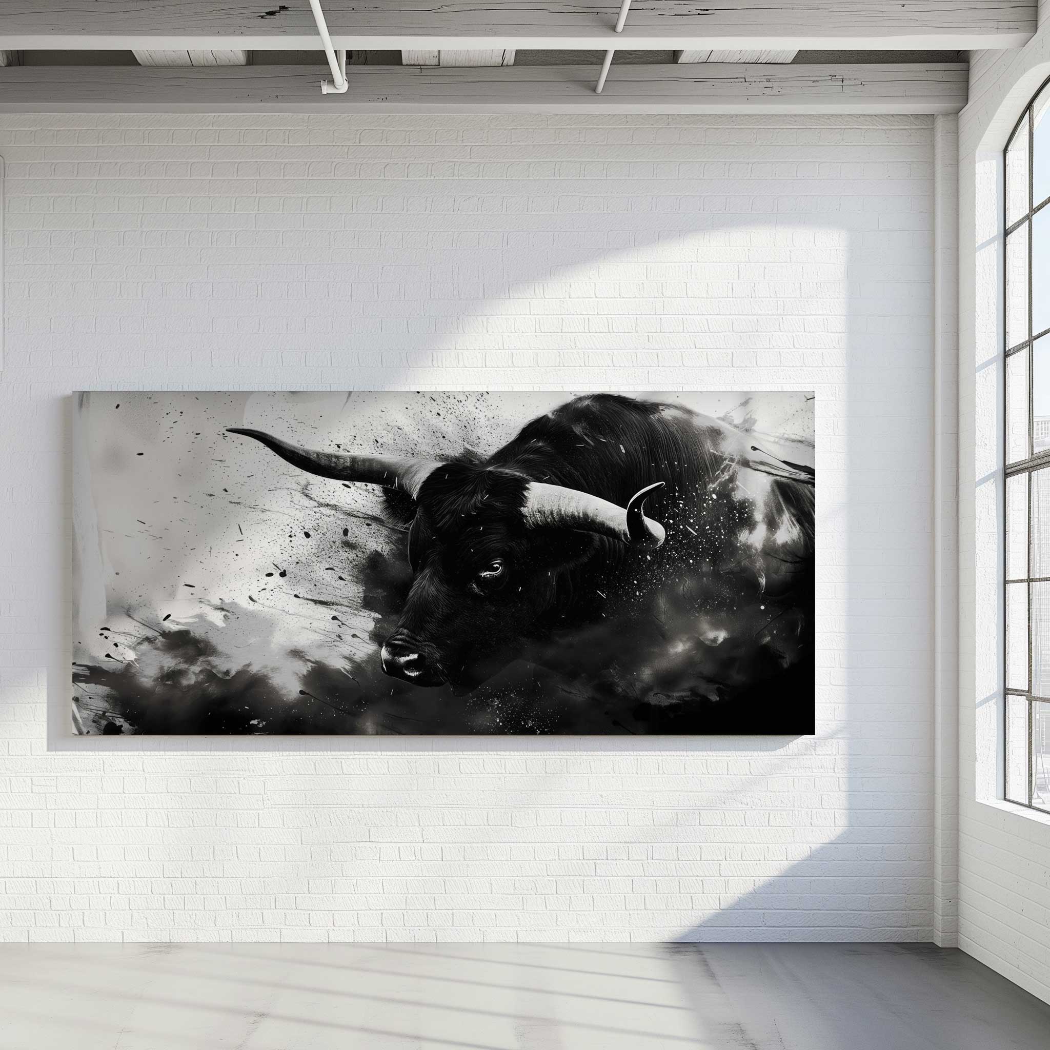 Modernes Wandbild eines schwarzen Stiers mit ausdrucksstarken Hörnern in monochromem Stil, inszeniert mit Rauch- und Sprenkeleffekten – Fine Art Print auf Alu-Verbund in heller Galerieumgebung mit Backsteinwand